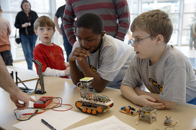 Children being shown how to make robot vehicles