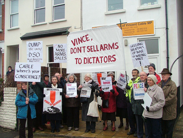 Protesters with banners outside Vince Cable&#039;s constituency office