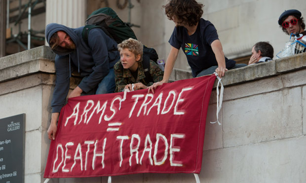 Protesters hang a banner outside the National Gallery saying "ARMS TRADE = DEATH TRADE"