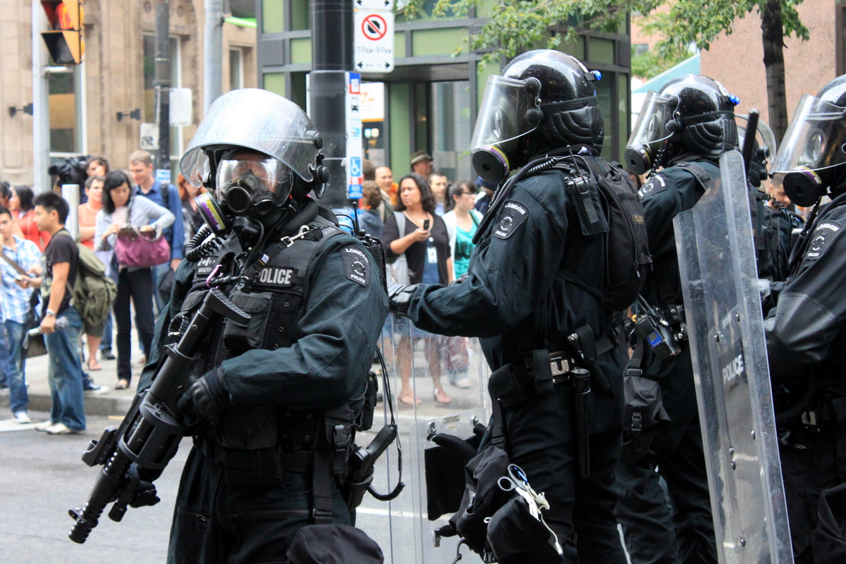 Two police officer in heavy riot hear and carrying guns