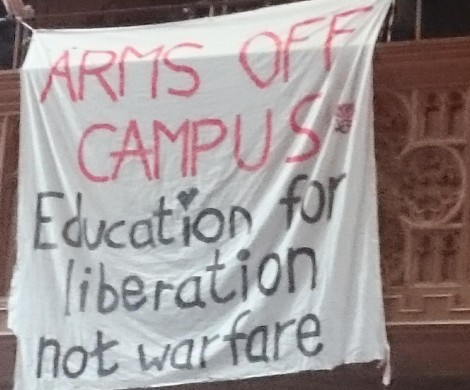 A banner that says "Arms off campus. Education for liberation not warfare.