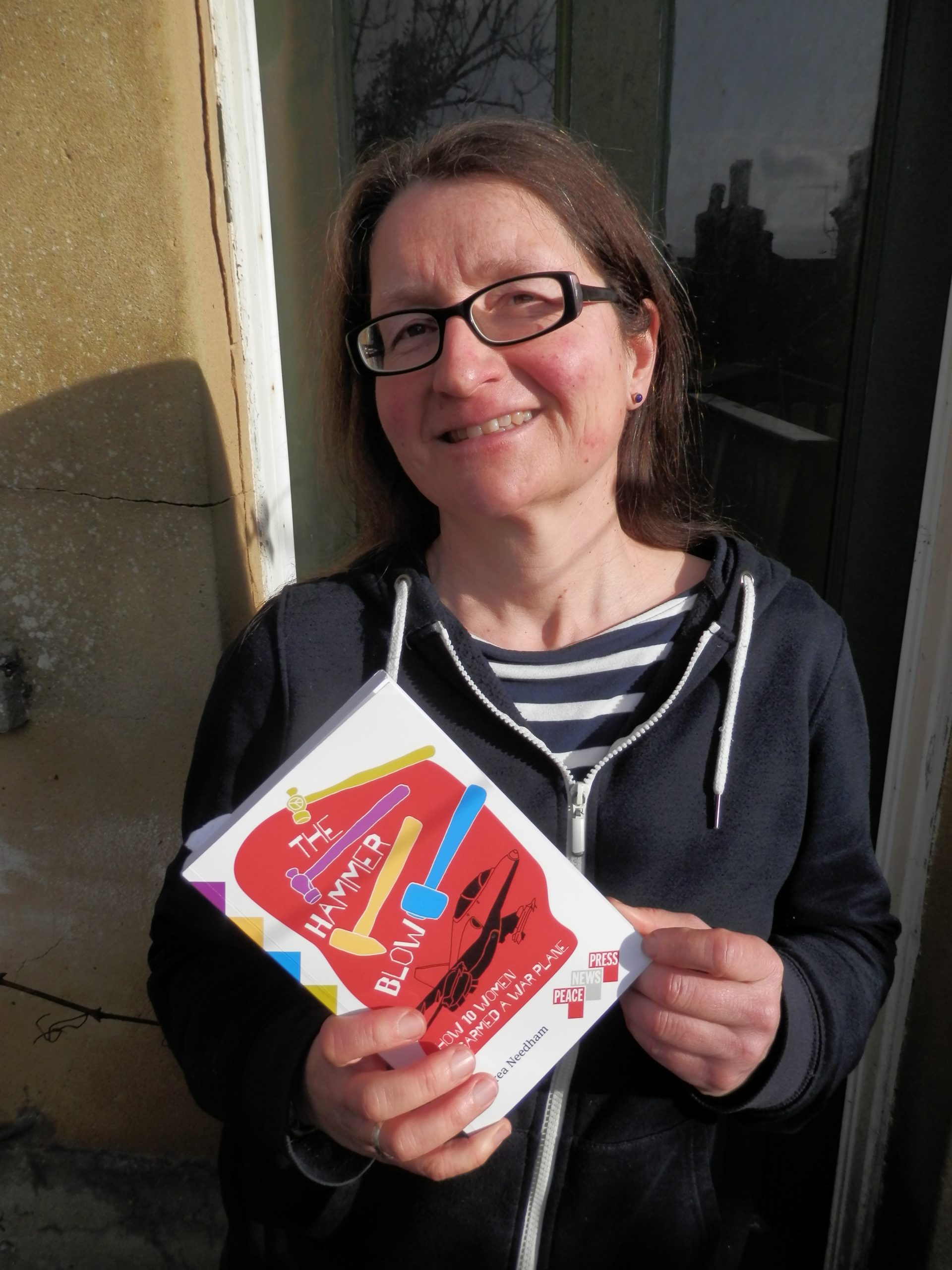 Andrea Needham with a copy of The Hammer Blow
