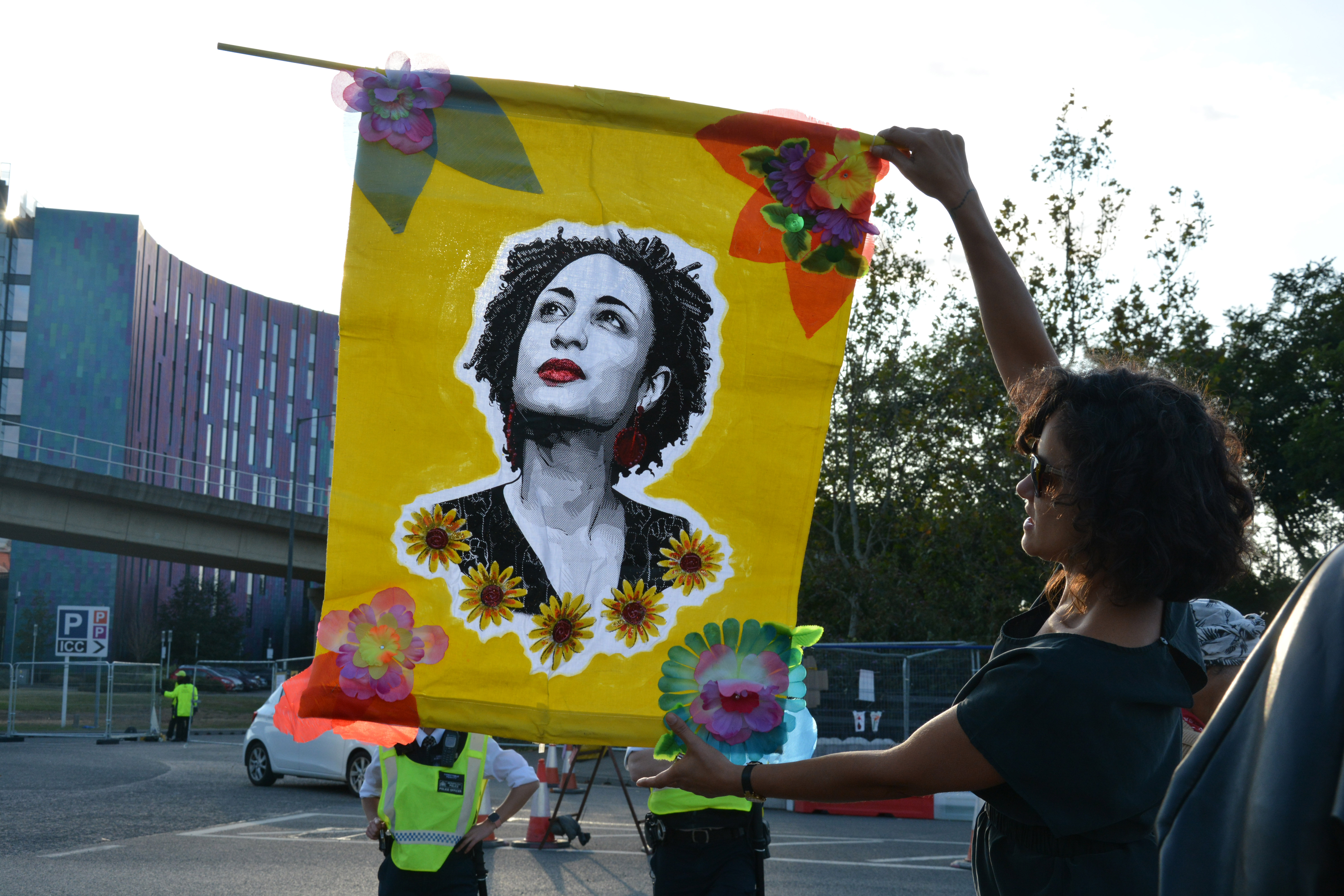 Protester unfurls a banner outside DSEI arms fair