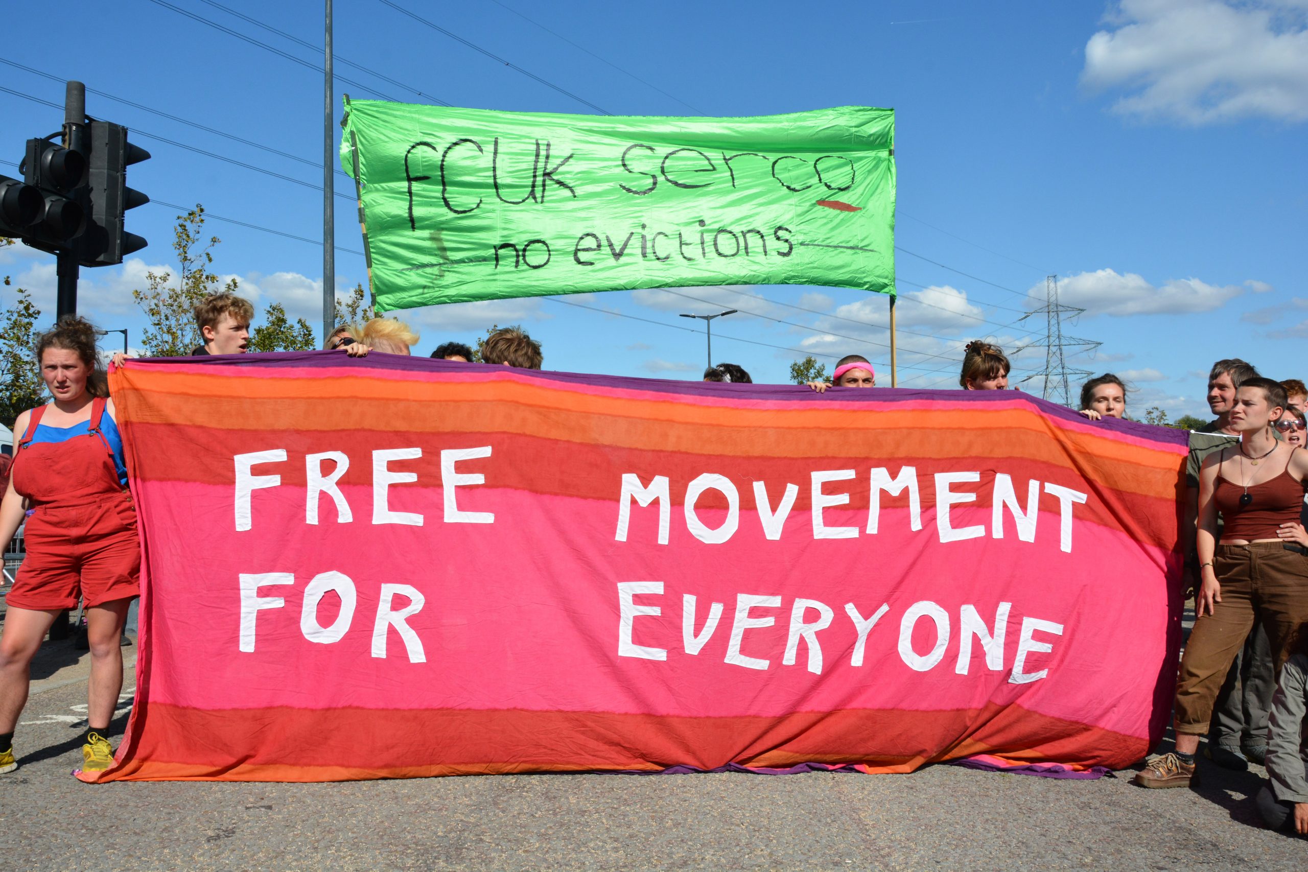 Activists with banner that reads 'free movement for everyone.'