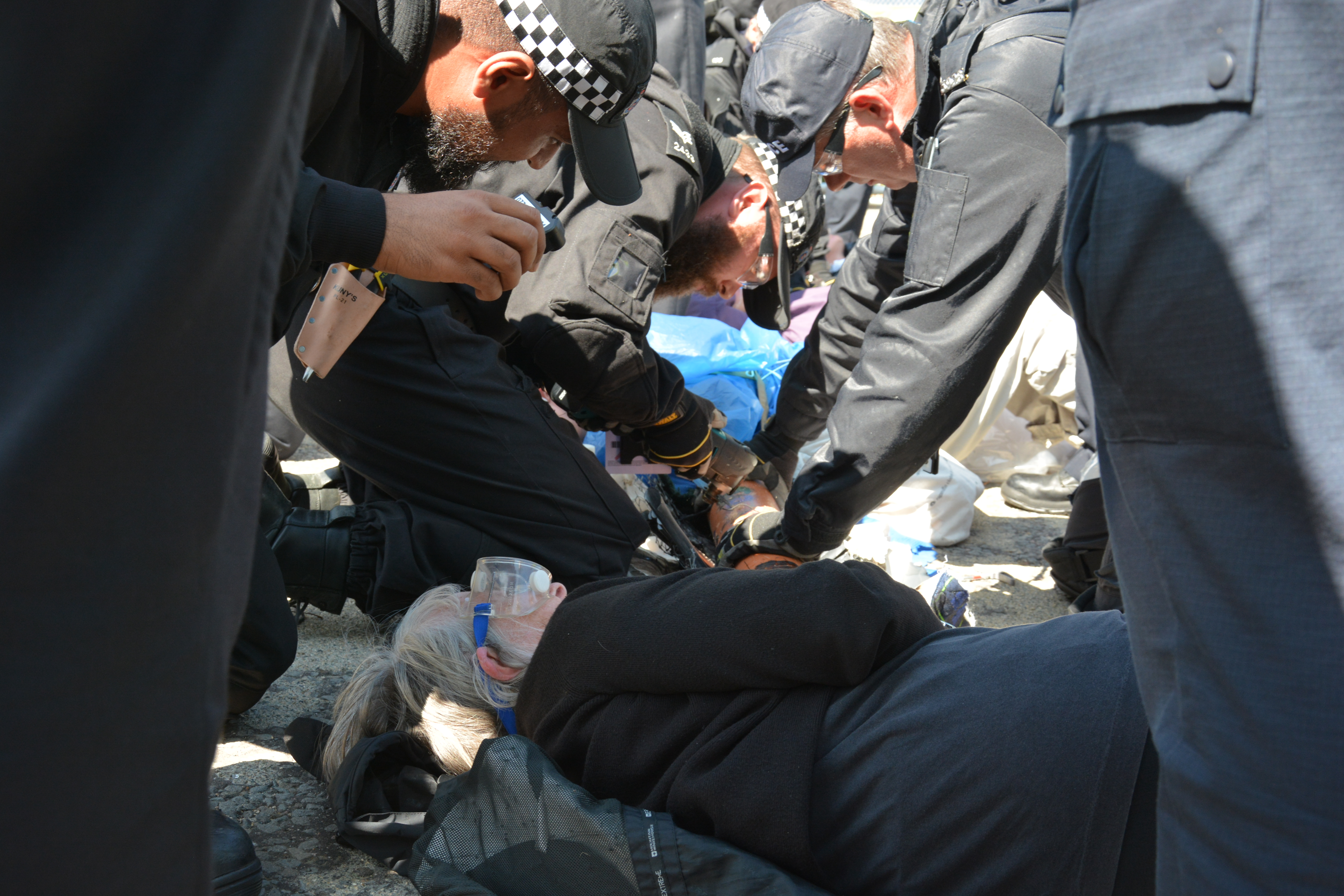 The police cutting team works its way through an arm tube