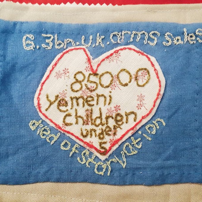 A stitched heart shape and wording saying: '6.3bn UK arms sales' and '85000 Yemeni children under 5 died of starvation'' 