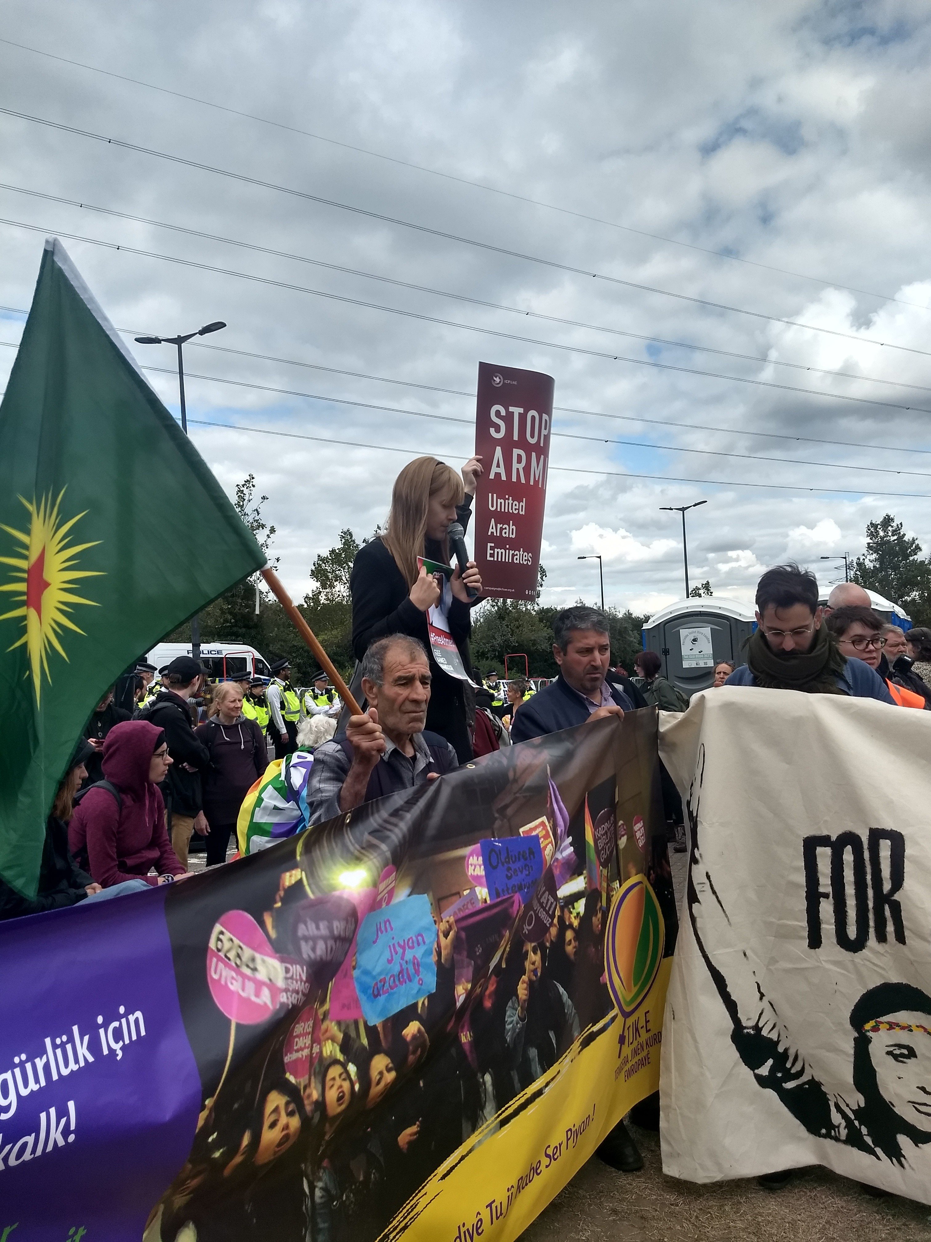 Campaigner with banner that reads 'stop arming United Arab Emirates' outside DSEI