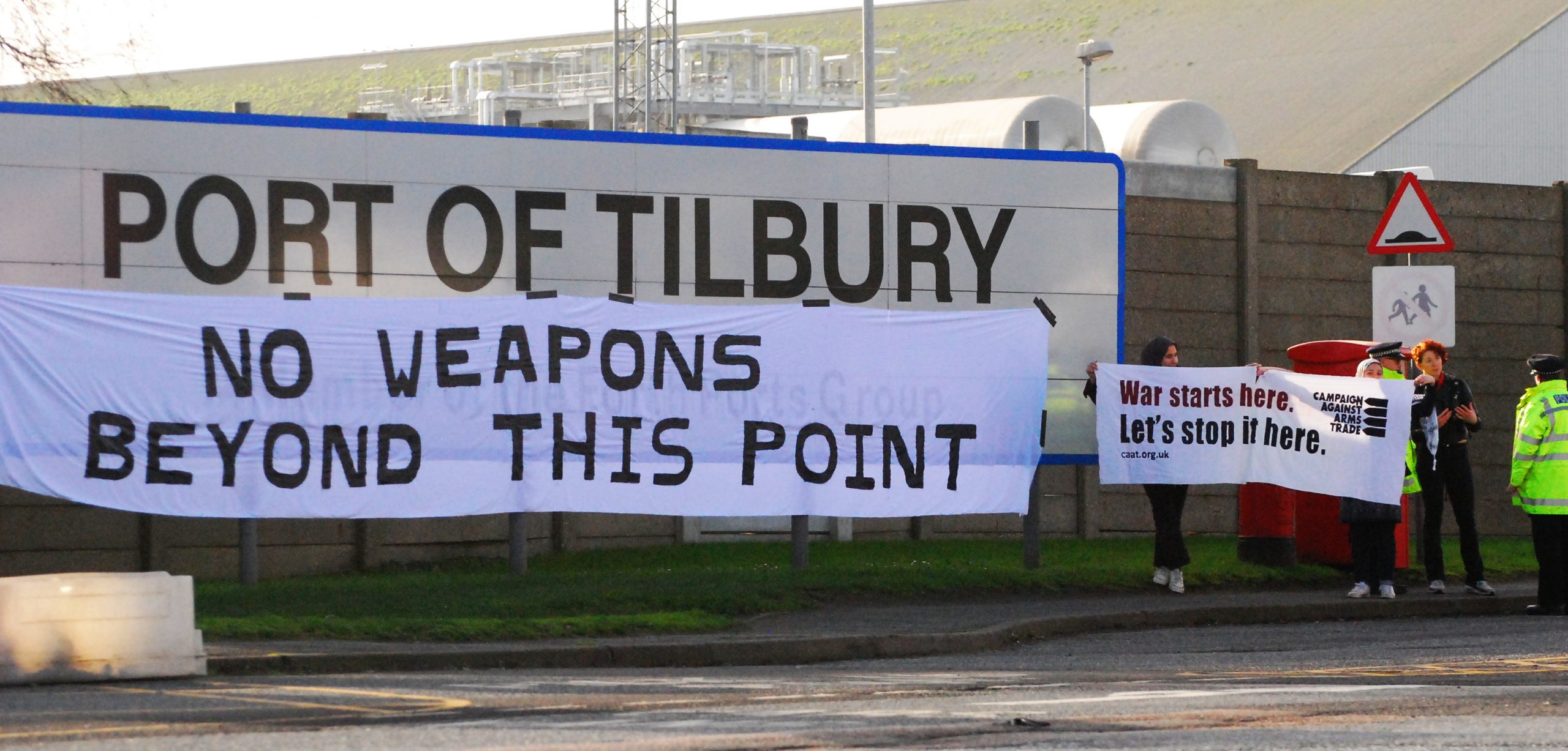 &#039;no weapons beyond this point&#039; banner hangs below Port of Tilbury sign