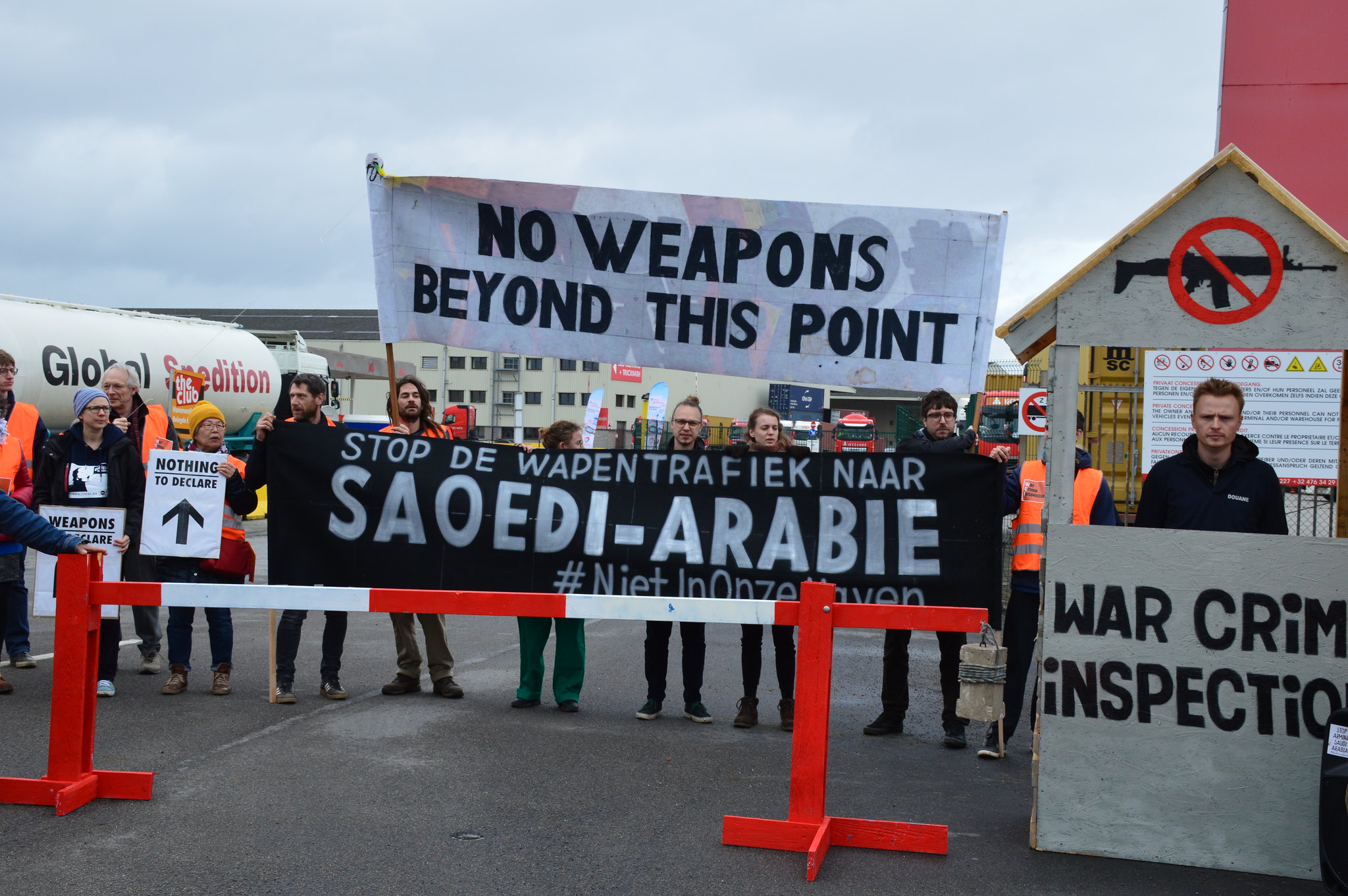 Protesters take action at Antwerp docks with banner saying no weapons beyond this point