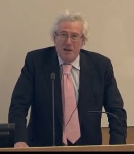 Lord Sumption in black jacket and pink tie