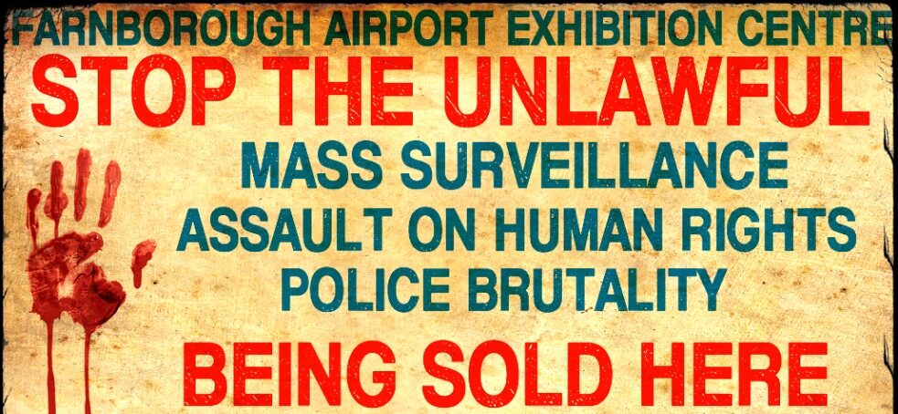 Banner says stop the unlawful mass surveilance assault on human rights being sold here March 9-11