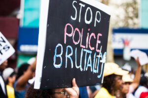 Protester with sign that reads 'stop police brutality.'