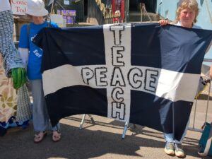 Banner with the Cornish flag with Teach Peace written in the cross