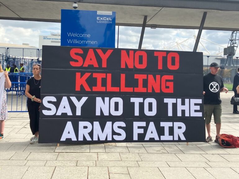 Large banner reading Say No to Killing. Say No to the arms fair outside the ExCeL centre