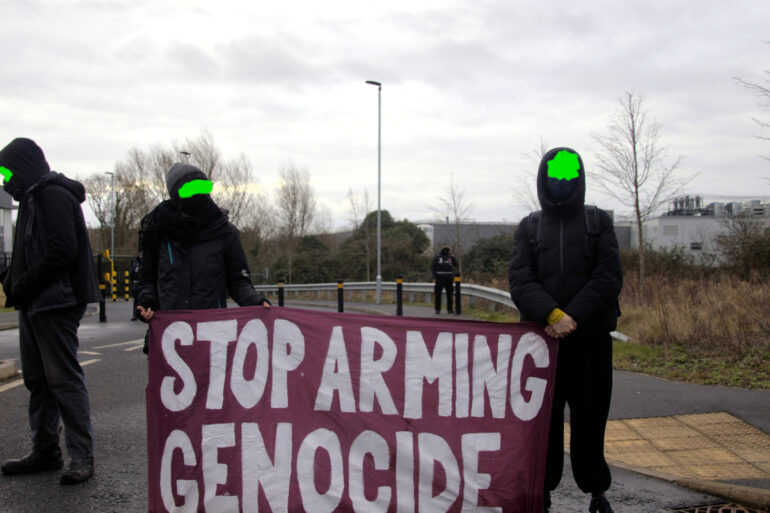 Protesters at Elbit in Bristol with banner that reads Stop Arming Genocide
