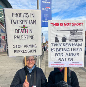 2 protesters with excellent home made placards outside the stadium.